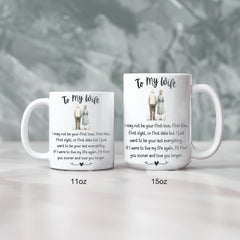 A white ceramic mug with black text and illustrations of a man and a woman holding hands. The text is a love letter to a wife, expressing love and regret for not being the first love.
