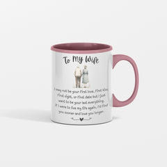 A white ceramic mug with black text and illustrations of a man and a woman holding hands. The text is a love letter to a wife, expressing love and regret for not being the first love.